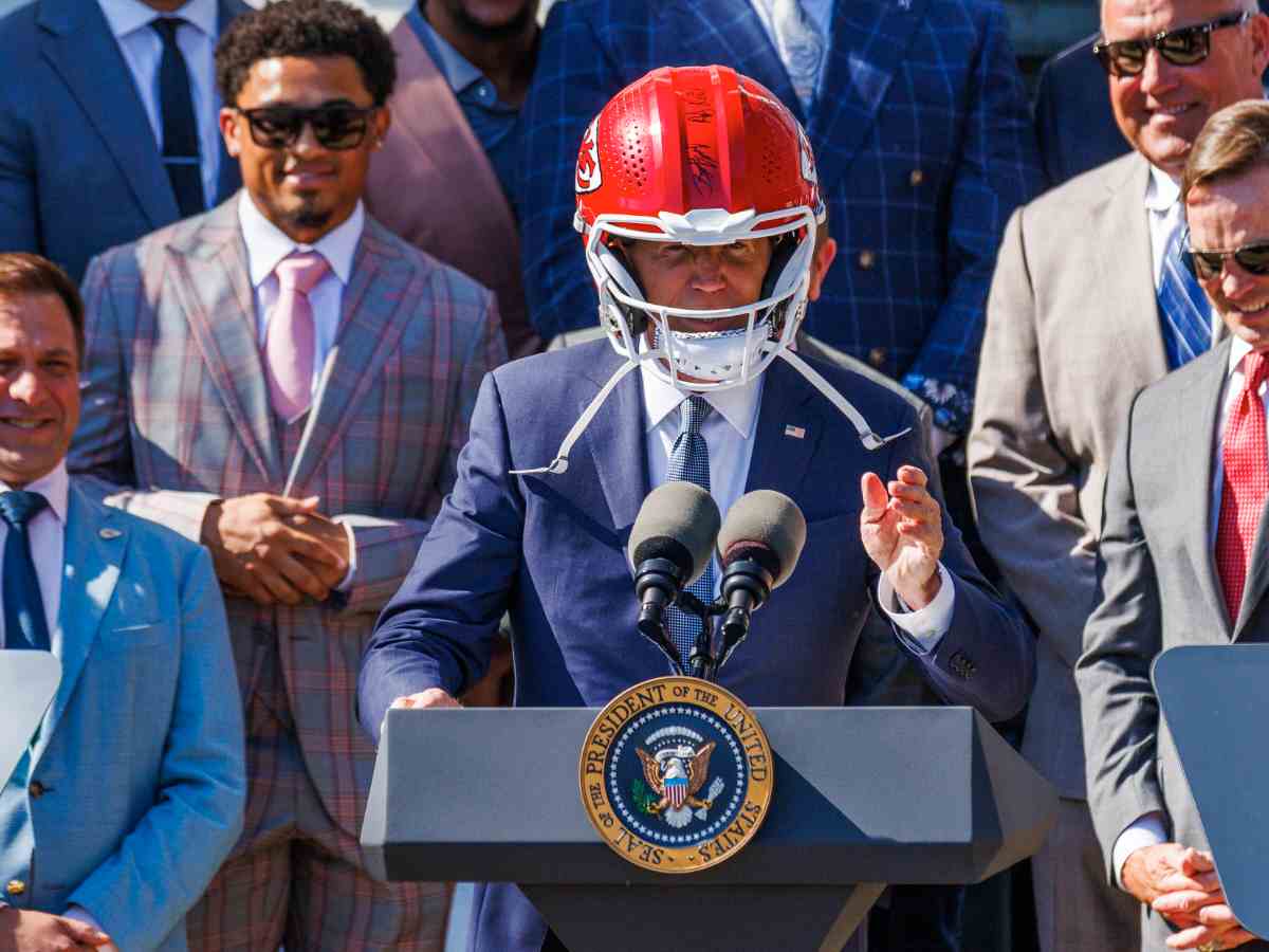 Andy Reid makes President Joe Biden try a Chiefs helmet which he sports after one unsuccessful attempt at White House