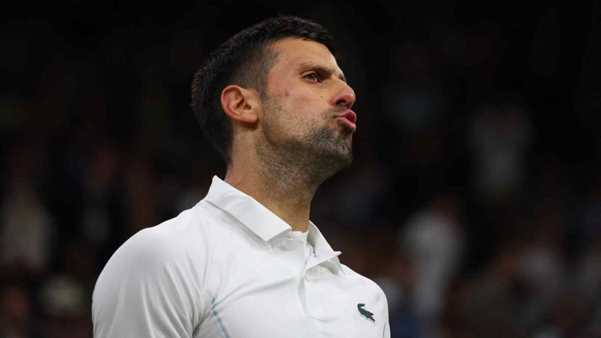 Novak Djokovic gesturing towards the spectators who are booing him in his men's singles match against Holger Rune