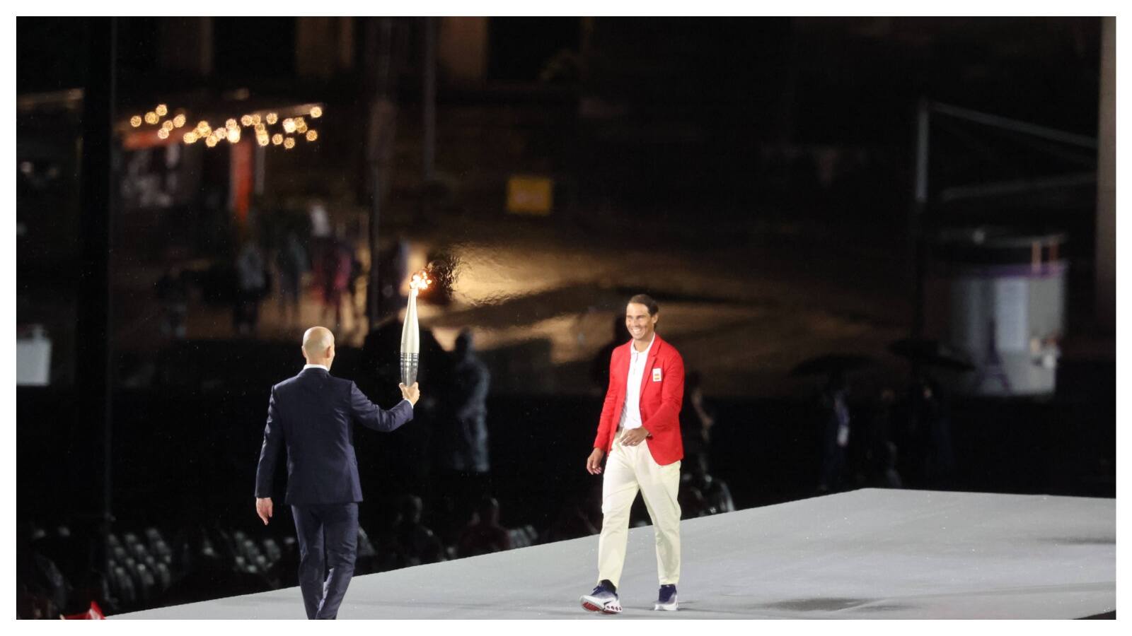 WATCH: “From being booed in Paris to this” – Fans go berserk as Zinedine Zidane passes the Olympic torch to Rafael Nadal 