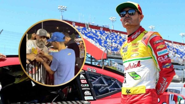 Kyle Larson sign autographs for fans.