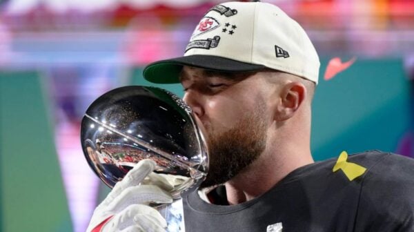 Travis Kelce kissing Vince Lombardi Trophy